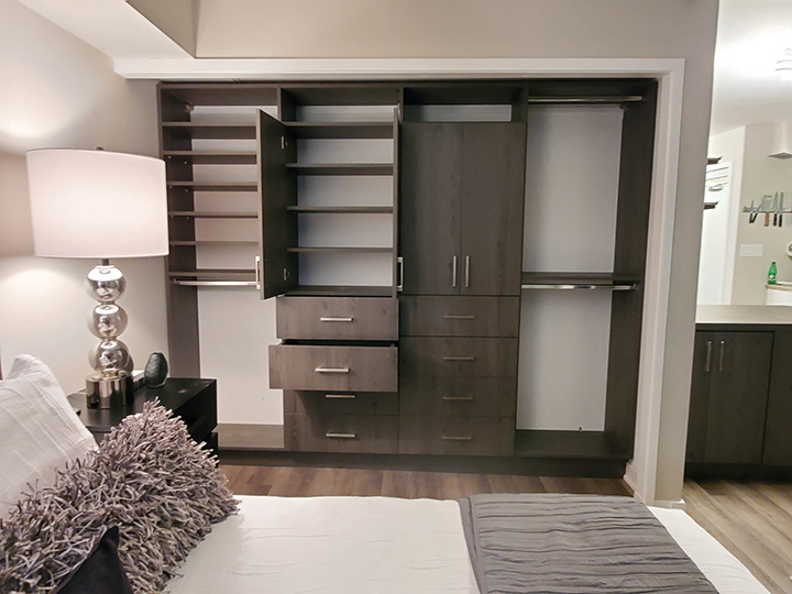 An interior of a house with light color walls and brown cabinets